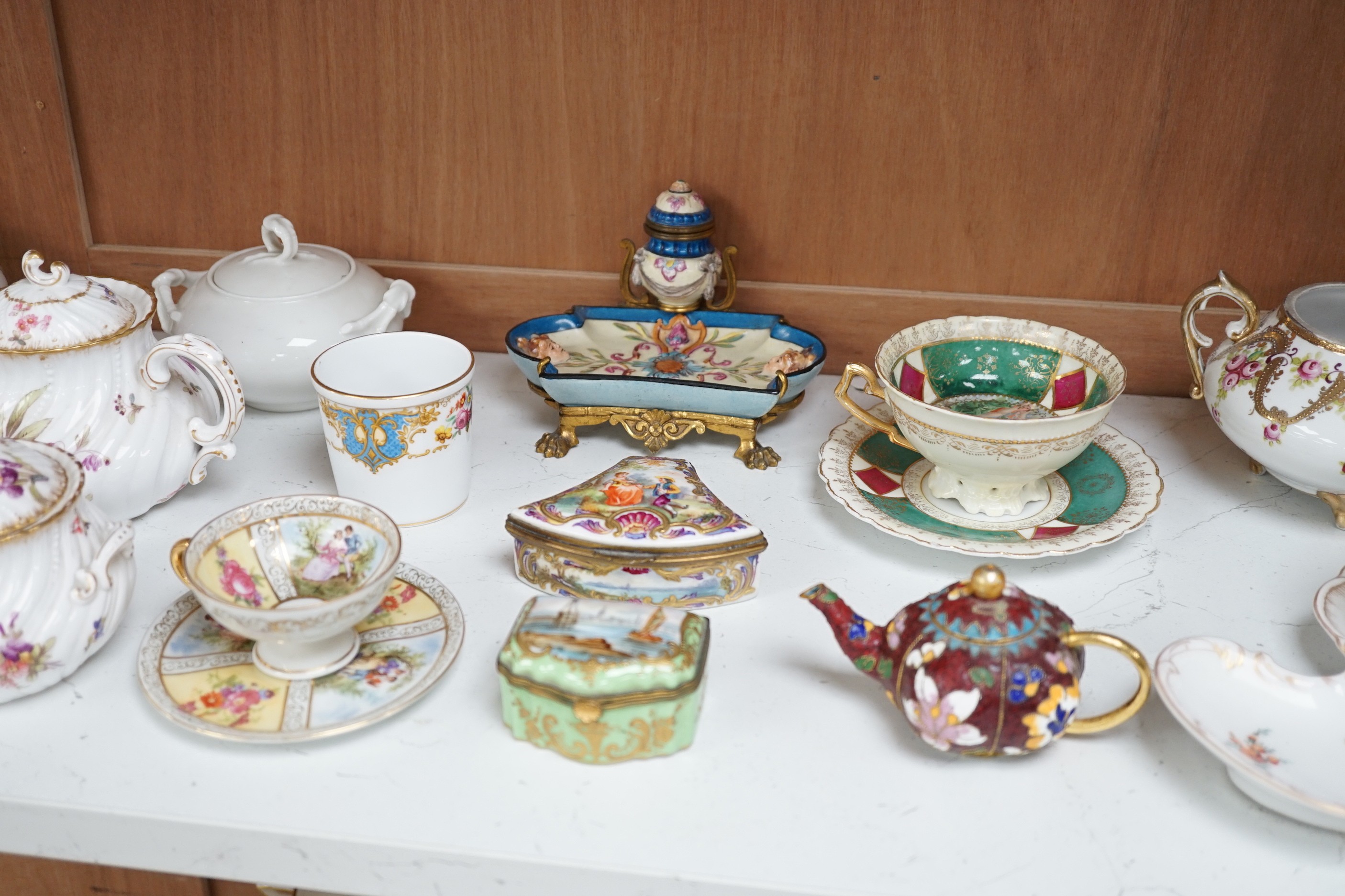 A large group of continental ceramics to include mainly 19th century including one piece of Zsolnay, Dresden wares, trinket boxes, a pottery and gilt metal mounted inkstand etc